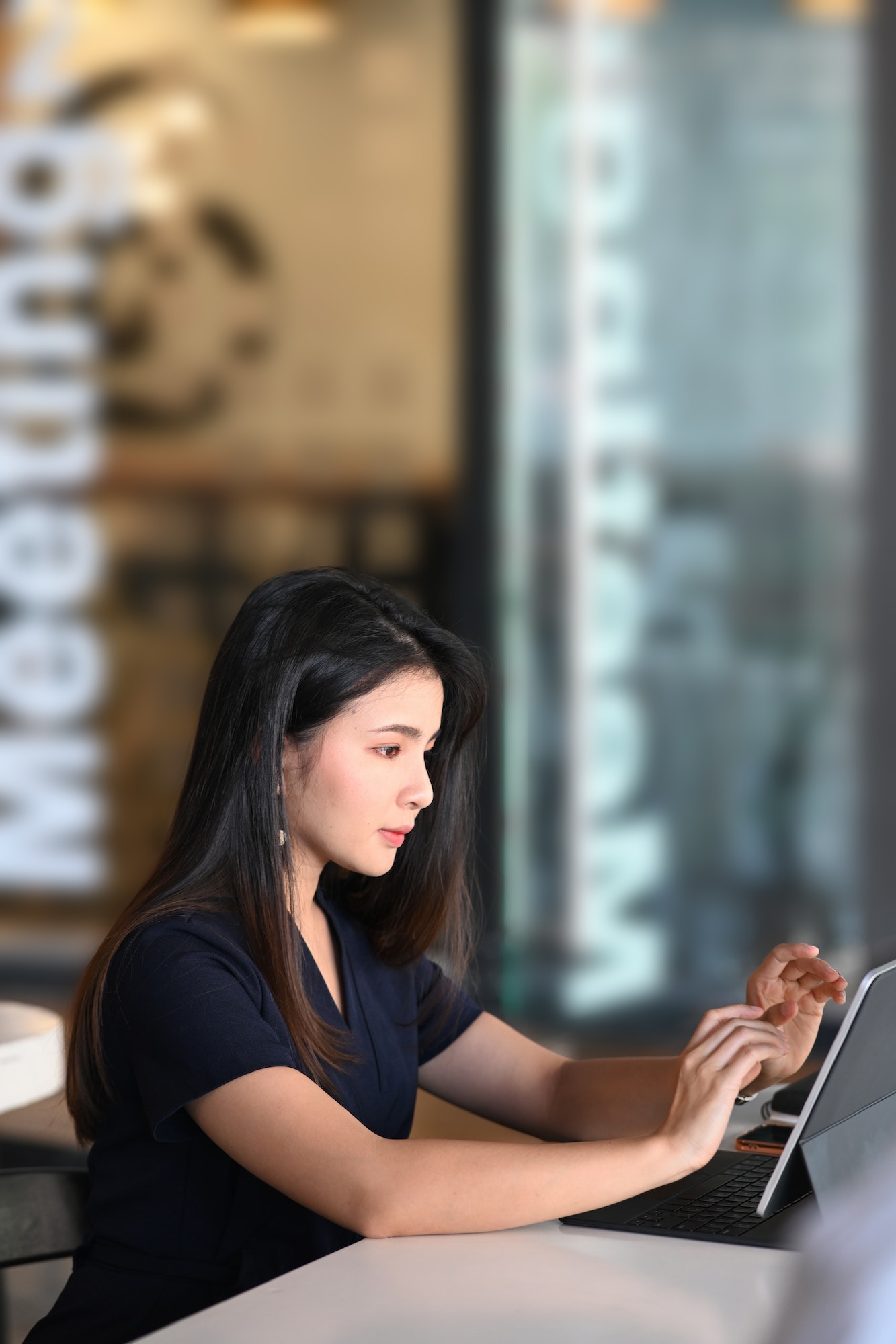 Portrait of businesswoman using tablet computer analyzing business data at her workplace.